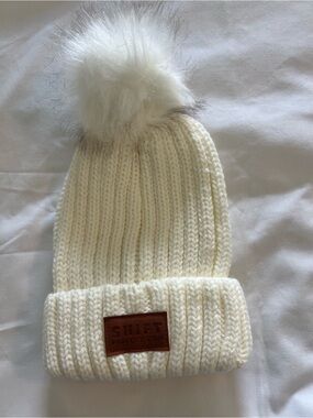 LEEMAN NEWYORK Ivory Knit Beanie with White Faux Fur Pom and fax leather Patch